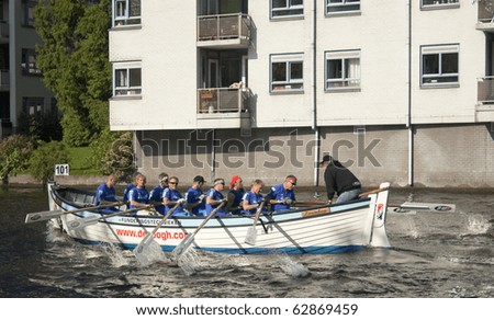 AMSTERDAM, THE NETHERLANDS - OCT 9: Rowing team from the city of Zaandam participates in the annual 25 km long canal race, October 9, 2010 in Amsterdam, The Netherlands