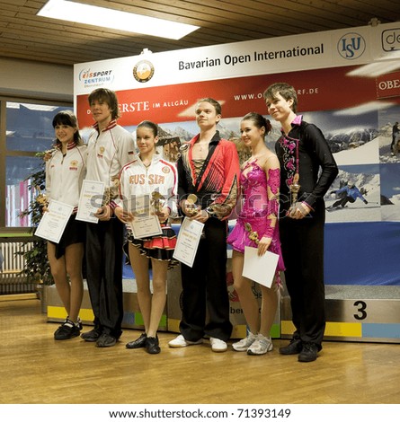 OBERSTDORF, GERMANY - FEBRUARY 13: Winners of junior ice dance competition pose for photographs during the medal ceremony at Bavarian Open on February 13, 2011 in Oberstdorf, Germany