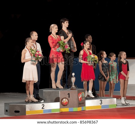 OBERSTDORF, GERMANY - SEPT 24: First place winners Madison Hubbel and Zachary Donohue on the podium, with other winners, during the medal ceremony at Nebelhorn Trophy on September 24, 2011 in Oberstdorf, Germany