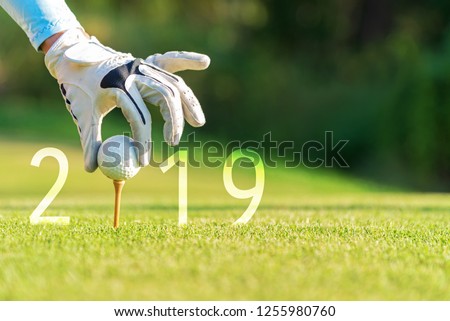 Golfer asian woman putting golf ball for Happy New Year 2019 on the green golf, copy space. Healthy and Holiday Concept.