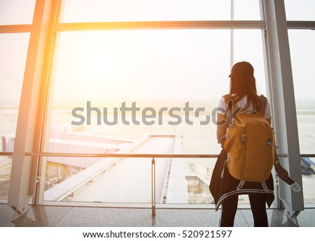 Traveler woman at the airport window