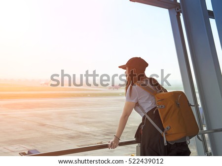 Traveler woman at the airport window, soft and select focus