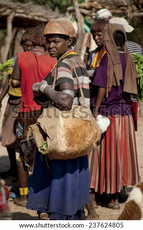 TURMI, OMO VALLEY, ETHIOPIA - NOVEMBER 19, 2011: Unidentified Hamar woman at village market. Weekly markets are important events in Omo Valley tribal life.