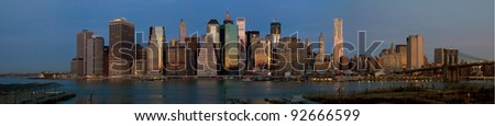 Panorama of Manhattan skyline early in the morning as the sun is rising creating a glowing city