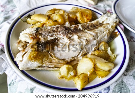 cooked sea bass on top a plate in my house