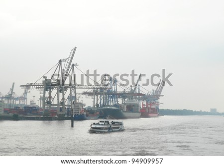 HAMBURG, GERMANY - AUGUST 12: Ships at Hamburg harbor on August 12, 2010. Hamburg is the biggest port of Germany, covering an area of 74 km², handling almost 10 million containers a year.