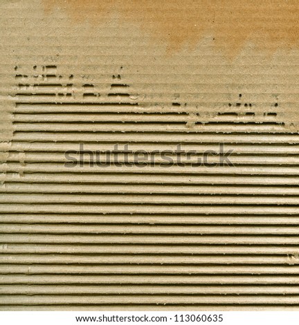Textured corrugated striped cardboard with natural fiber parts