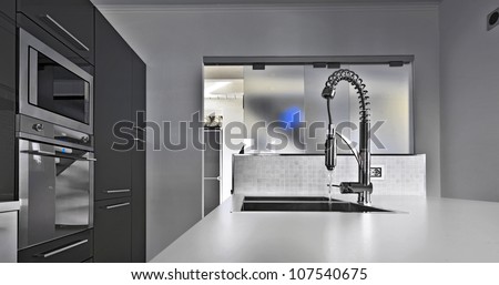 modern kitchen with steel faucet and sliding glass door