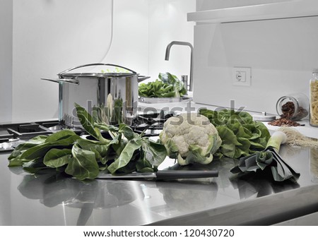 vegetables on the steel worktop in a modern kitchen