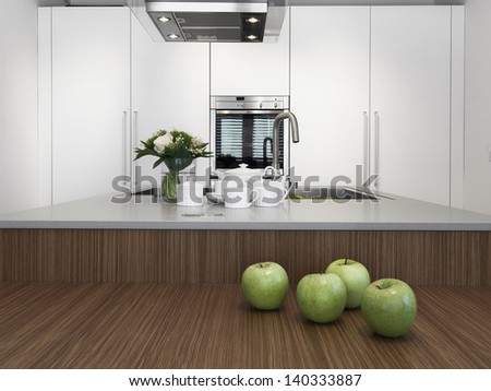 green apples and dishes on the wood worktop in the modern kitchen with vase of flowers