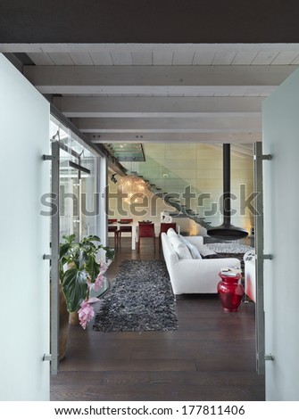 modern entrance in the attic room with sofa and wood ceiling
