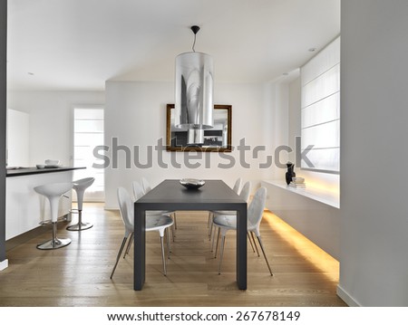 modern dining room with dining table and wood floor overlooking on the ktichen