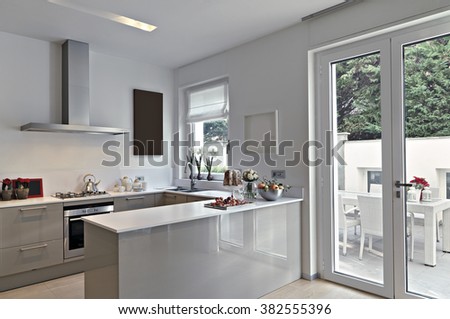 view of a modern kitchen with kitchen island overlooking on the terrace