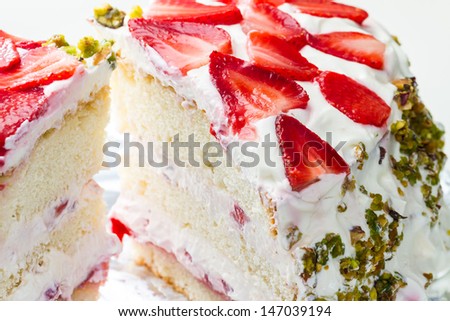 A big piece of a fresh strawberry cream cake.
