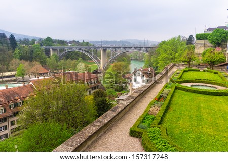 Aar river in city of Berne with landscaped gardens in foreground.