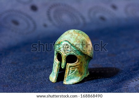 Model of ancient Greek battle helmet.