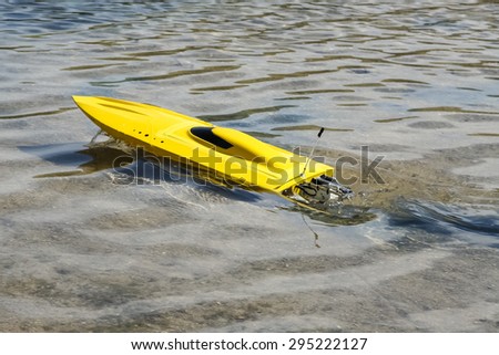 Modern electric radio controlled boat sailing on water.