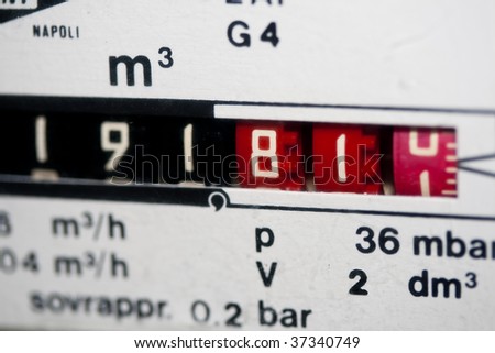 A closeup view of the dial or face of a metric gas meter.