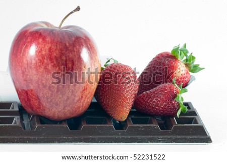Fresh strawberries ,chocolate and apple on a white background
