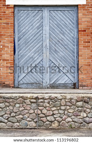 blue wooden plank doors, stone foundation