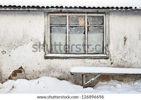 wall with window background, bench near the wall, slate roof and tin rainwater pipe