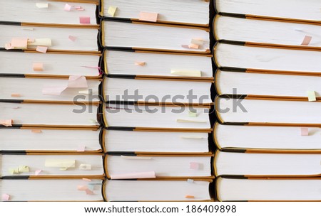 stack of books with color sticky notes