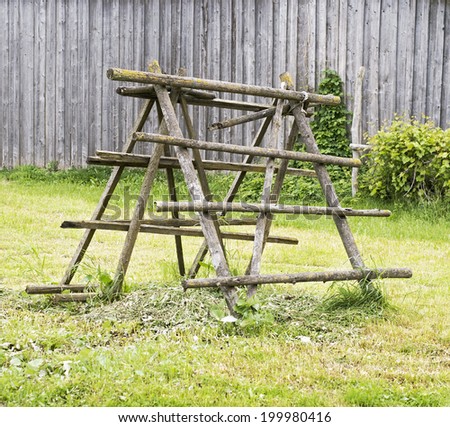 old wooden rack near the wooden barn