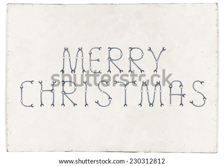 Merry Christmas greetings slogan made of spanners, plywood board background