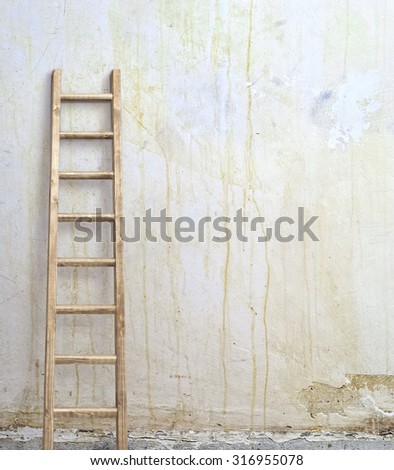 weathered stucco wall with wooden ladder background