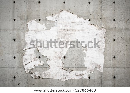 Old billboard with torn poster, wall with holes