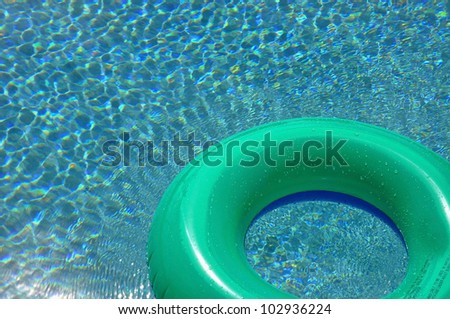 Green pool float / ring in swimming pool room for your text