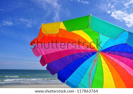 Colorful Beach Umbrella at beach, room for your text