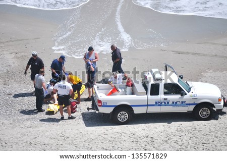 MYRTLE BEACH, SOUTH CAROLINA - APRIL 18 - Paramedics, Beach Police, Lifeguard work together to save unidentified drowning victim at Myrtle Beach on the 18th of April 2013