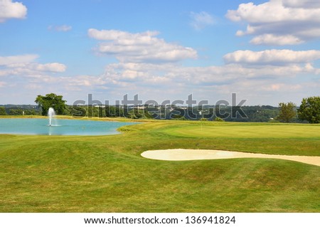 Golf green with pond and sand trap