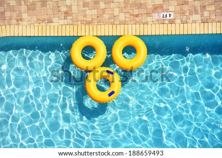 Yellow pool rings floating in a swimming pool