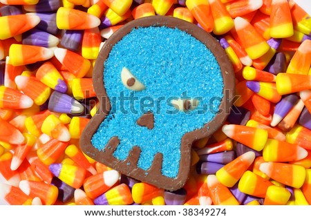 halloween image chocolate candy skull sitting on candy corn background