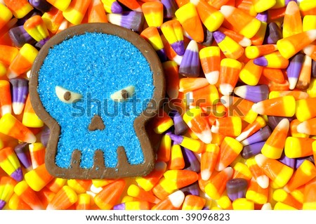 halloween image chocolate candy skull sitting on candy corn background