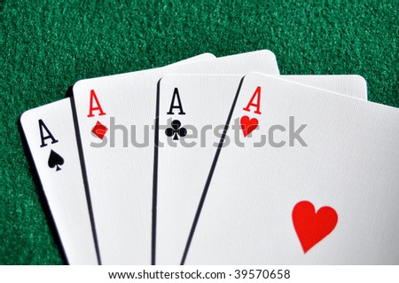 four aces fanned out on poker table