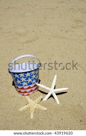 patriotic beach bucket and starfish on sand perfect for cover art
