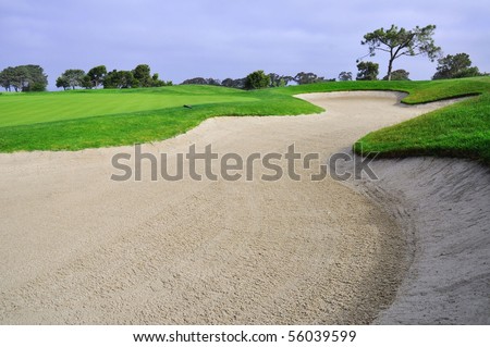 Landscape shot of Golf course with large sand trap.