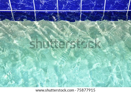 Pretty blue pool water with blue tile. Room for your text