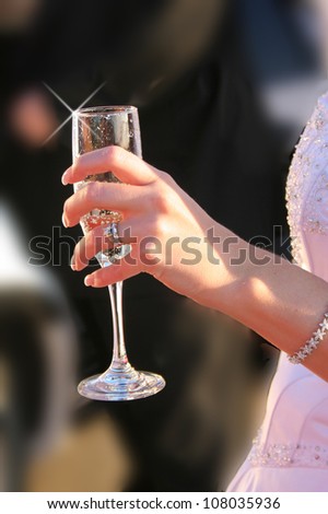 Bride with wine glass on wedding day