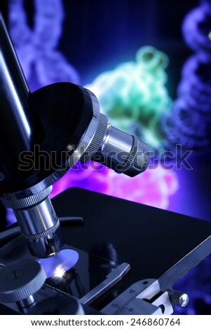 A black and silver microscope against a screen showing the repair process of a DNA sequence