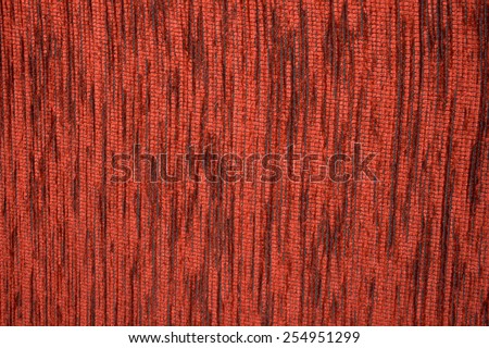 Claret red velvet applied to a dark textile mesh structure, on a chair