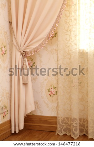 Part Of Beautifully Draped Curtain And Wall With Patterns