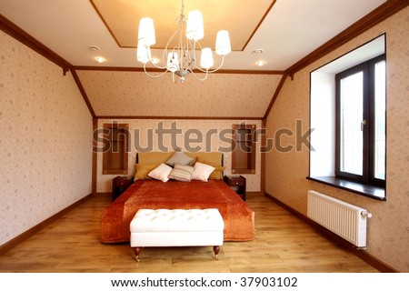 The big wide bed in a convenient modern bedroom with set of pillows