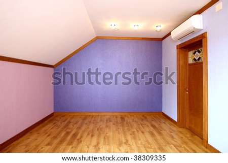 Room without furniture with a parquet floor, blue both pink walls and a wooden door