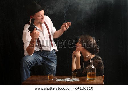 The man-gangster and the beautiful girl talk in a bar