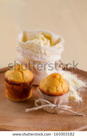 Corn muffins and a bag of flour on the round board