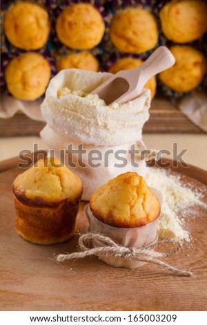 Corn muffins and a bag of flour on background muffin packaging
